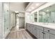 Modern bathroom featuring double sinks, a shower, and walk-in closet with bright natural lighting at 3327 S Felix Way, Chandler, AZ 85248