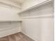 Walk-in closet with shelving and neutral colored carpet at 3327 S Felix Way, Chandler, AZ 85248