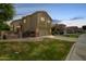 Exterior view of a home featuring a two-car garage, manicured lawn, and a paver driveway at 3327 S Felix Way, Chandler, AZ 85248