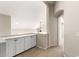 Hallway features a built-in white cabinet with black hardware and an open doorway at 3327 S Felix Way, Chandler, AZ 85248