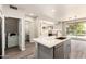 Modern kitchen featuring an island sink, stainless steel appliances and view to the backyard pool at 3327 S Felix Way, Chandler, AZ 85248