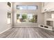 Spacious living room with hardwood floors, high ceilings, and large windows overlooking the backyard and pool at 3327 S Felix Way, Chandler, AZ 85248