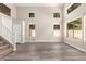 Bright living room showcasing tall ceilings, hardwood floors, staircase, and large windows at 3327 S Felix Way, Chandler, AZ 85248