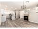 Open concept kitchen and living room with a fireplace and hardwood floors at 3327 S Felix Way, Chandler, AZ 85248