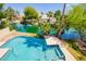 Aerial view featuring a backyard swimming pool overlooking a tranquil lake and lush tropical landscaping at 3327 S Felix Way, Chandler, AZ 85248