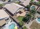 Aerial view of a backyard with a pool, covered patio and lush greenery at 2390 S Walnut Dr, Chandler, AZ 85286