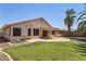 Beautiful backyard featuring lush green lawn, a pool, and covered patio for outdoor entertaining at 2390 S Walnut Dr, Chandler, AZ 85286