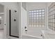 Bright bathroom featuring a glass shower stall, soaking tub and a window made of glass blocks at 2390 S Walnut Dr, Chandler, AZ 85286