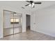 Bedroom with tiled floors, ceiling fan, and sliding closet door at 2390 S Walnut Dr, Chandler, AZ 85286