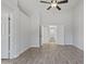 Bright, open bedroom featuring wood-look tile floors, ceiling fan and white painted walls at 2390 S Walnut Dr, Chandler, AZ 85286