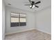 Bright bedroom featuring tiled floors, a ceiling fan and a large window overlooking the property at 2390 S Walnut Dr, Chandler, AZ 85286