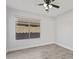 Bright bedroom featuring tiled floors, a ceiling fan and a window overlooking the property at 2390 S Walnut Dr, Chandler, AZ 85286