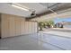 Spacious garage with epoxy flooring, and ample storage cabinets for organization and functionality at 2390 S Walnut Dr, Chandler, AZ 85286