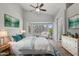 Serene primary bedroom featuring a bay window, ceiling fan, and light hardwood floors at 2390 S Walnut Dr, Chandler, AZ 85286