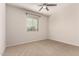 Bright bedroom with neutral carpet and a window with blinds, and a ceiling fan at 22882 E Marsh Rd, Queen Creek, AZ 85142