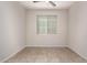 Neutral bedroom with a ceiling fan and window, offering natural light at 22882 E Marsh Rd, Queen Creek, AZ 85142