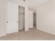 Bedroom with neutral carpet, and white closet doors, offering ample storage space at 22882 E Marsh Rd, Queen Creek, AZ 85142