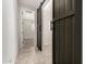 Hallway featuring a sliding barn door leading to another room with carpet at 22882 E Marsh Rd, Queen Creek, AZ 85142