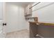 Functional laundry room with a wooden countertop, providing a convenient workspace at 22882 E Marsh Rd, Queen Creek, AZ 85142