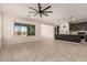 Bright living room featuring tile floors and an open floorplan to the kitchen with a large view window at 22882 E Marsh Rd, Queen Creek, AZ 85142