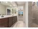 Main bathroom featuring double sinks, a walk-in shower, and neutral colors at 22882 E Marsh Rd, Queen Creek, AZ 85142