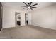 Main bedroom with an open doorway to main bathroom and dark accent wall at 22882 E Marsh Rd, Queen Creek, AZ 85142