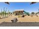 Fun playground with slides, climbing structures, and ride-on toys for children, set on a wood chip surface at 22882 E Marsh Rd, Queen Creek, AZ 85142