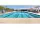 Community swimming pool showcasing swimming lanes, lounge chairs and shaded seating area with tables at 22882 E Marsh Rd, Queen Creek, AZ 85142