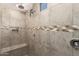 Close up of the shower with decorative tile accent and built in bench at 22882 E Marsh Rd, Queen Creek, AZ 85142