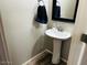 Small powder room with pedestal sink at 7213 S 12Th Pl, Phoenix, AZ 85042