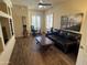 Cozy living room featuring a comfortable leather sofa, modern ceiling fan, and home office at 30793 N 77Th Way, Scottsdale, AZ 85266