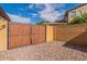 Private backyard access with a secure wooden gate at 42608 N 46Th Ave, New River, AZ 85087