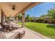 Relaxing covered patio with seating area and grassy lawn at 42608 N 46Th Ave, New River, AZ 85087