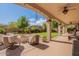 Spacious backyard patio with fire pit and seating at 42608 N 46Th Ave, New River, AZ 85087