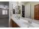 Clean bathroom with a double sink vanity and large mirror at 42608 N 46Th Ave, New River, AZ 85087