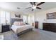 Bright bedroom with a king-size bed and ensuite bathroom access at 42608 N 46Th Ave, New River, AZ 85087