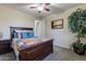 Bright bedroom featuring a king-size bed and built-in shelving at 42608 N 46Th Ave, New River, AZ 85087