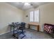 Cozy bedroom with a desk and window with plantation shutters at 42608 N 46Th Ave, New River, AZ 85087