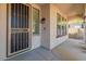 Covered entryway with security door and tiled flooring at 42608 N 46Th Ave, New River, AZ 85087