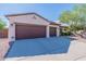 Front view of a house with a two-car garage and driveway at 42608 N 46Th Ave, New River, AZ 85087