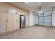 Large garage with ample storage cabinets and epoxy flooring at 42608 N 46Th Ave, New River, AZ 85087