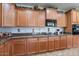 Spacious kitchen with ample cabinetry and granite countertops at 42608 N 46Th Ave, New River, AZ 85087