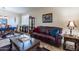 Living room with leather sofas and a coffee table, adjacent to dining area at 42608 N 46Th Ave, New River, AZ 85087