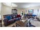 Living room with leather sofas, coffee table, and a view of dining area at 42608 N 46Th Ave, New River, AZ 85087