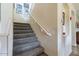 Carpeted staircase with a wooden railing and wall decor at 42608 N 46Th Ave, New River, AZ 85087