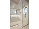 Open glass shower with marble herringbone flooring and built-in bench, complemented by a window view at 36323 N 100Th Way, Scottsdale, AZ 85262