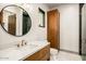Contemporary bathroom showcasing a vessel sink, wooden cabinetry, and a convenient toilet and shower at 36323 N 100Th Way, Scottsdale, AZ 85262