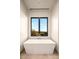 Bathtub under a window with beautiful countryside view, creating a serene and relaxing atmosphere at 36323 N 100Th Way, Scottsdale, AZ 85262