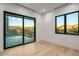 Modern bedroom with large sliding glass doors offering expansive desert views and natural light at 36323 N 100Th Way, Scottsdale, AZ 85262
