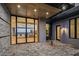 Contemporary home featuring a brick driveway and a modern glass front door, offering a peek into the living space at 36323 N 100Th Way, Scottsdale, AZ 85262